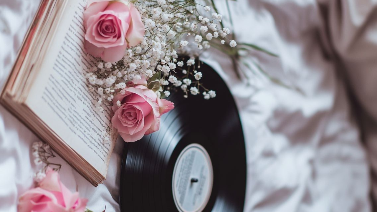 Record with pink roses and baby's breath on an open book