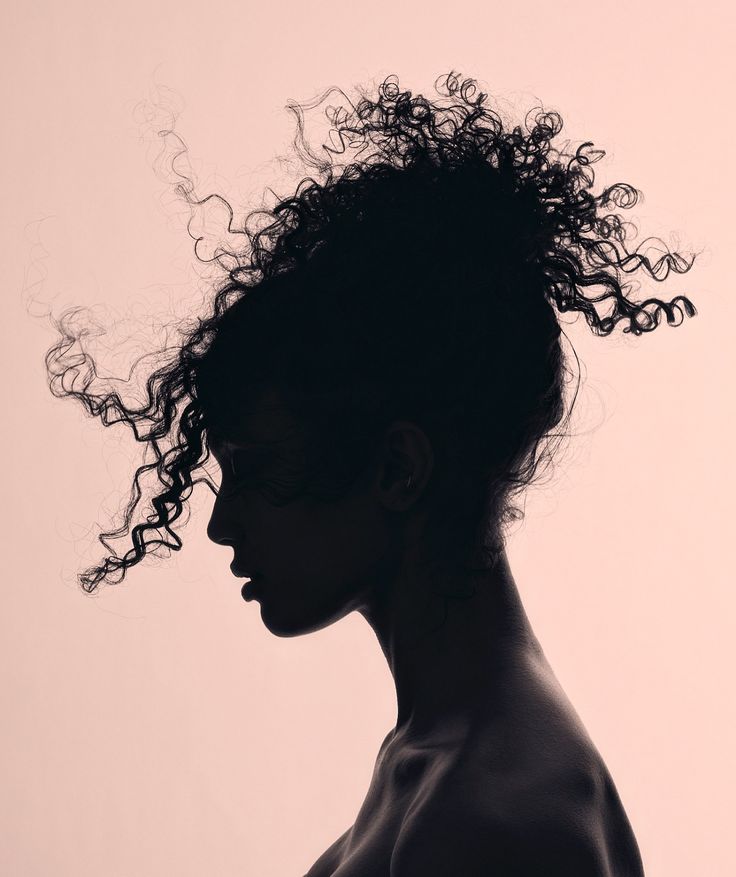Silhouette profile of a woman’s face against a soft background, representing introspection and personal transformation.