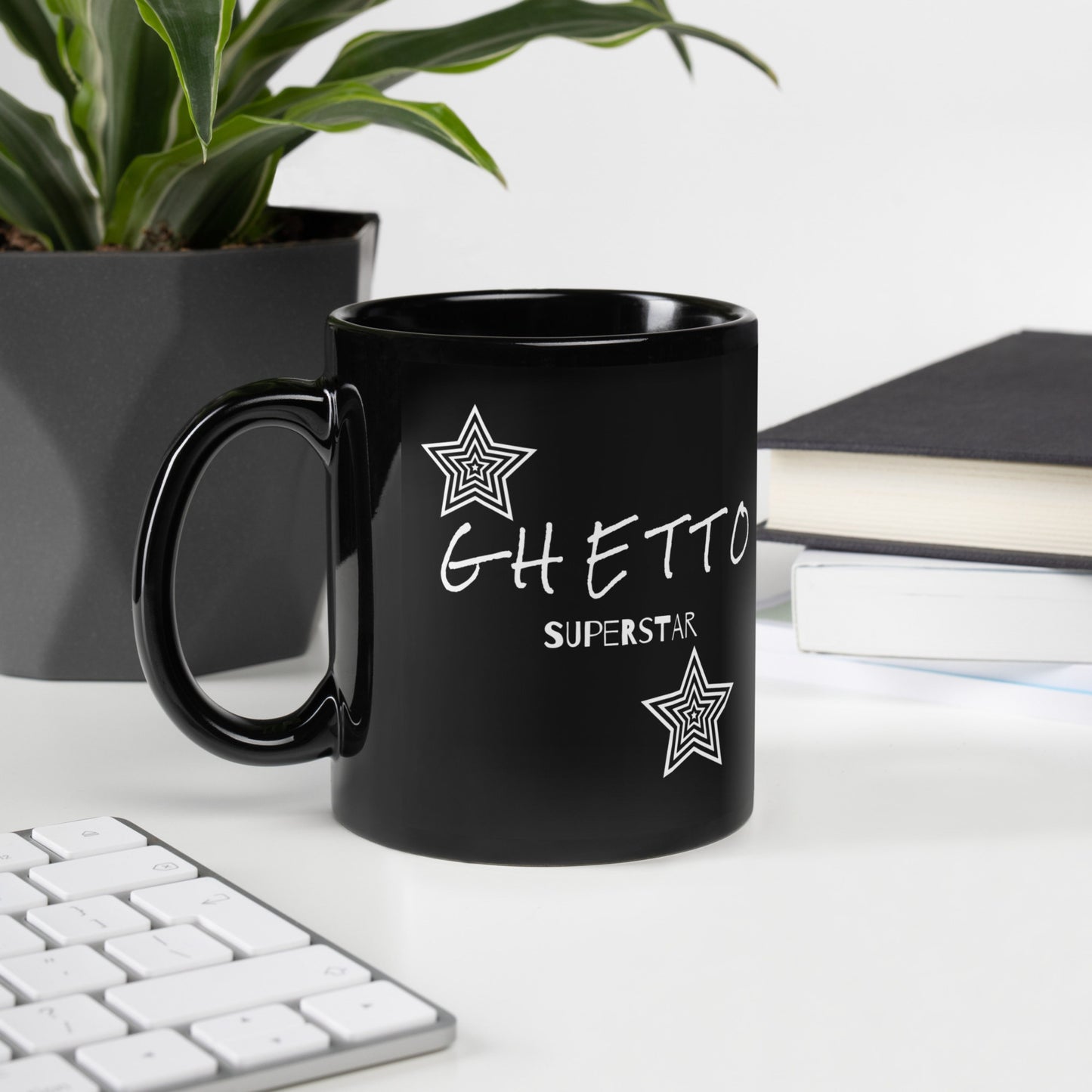 Black ceramic mug with bold “Ghetto Superstar” text inspired by Mýa’s song, featuring retro style and unapologetic vibe.