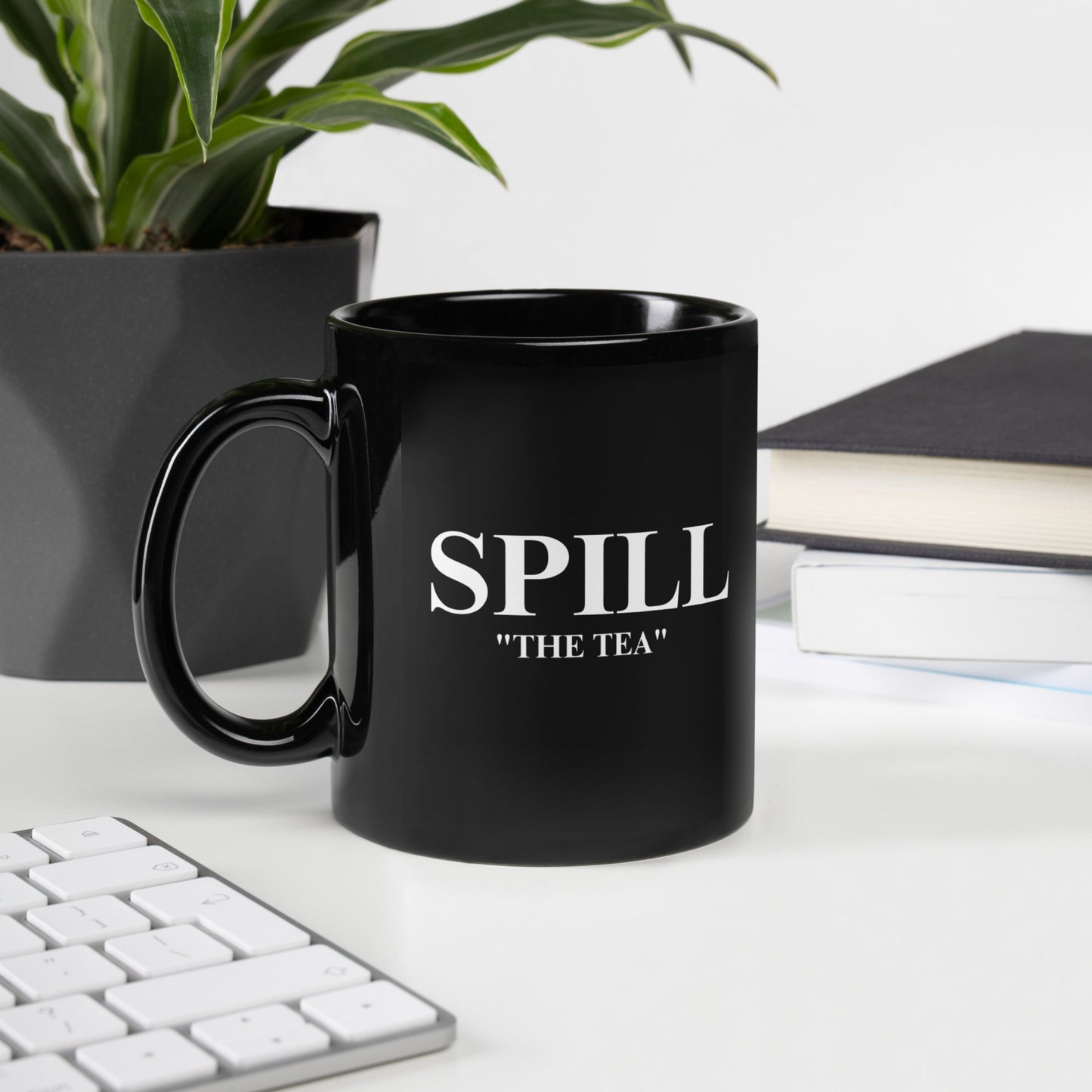 Black ceramic mug with bold “Spill the Tea” text, perfect for sipping and sharing truths