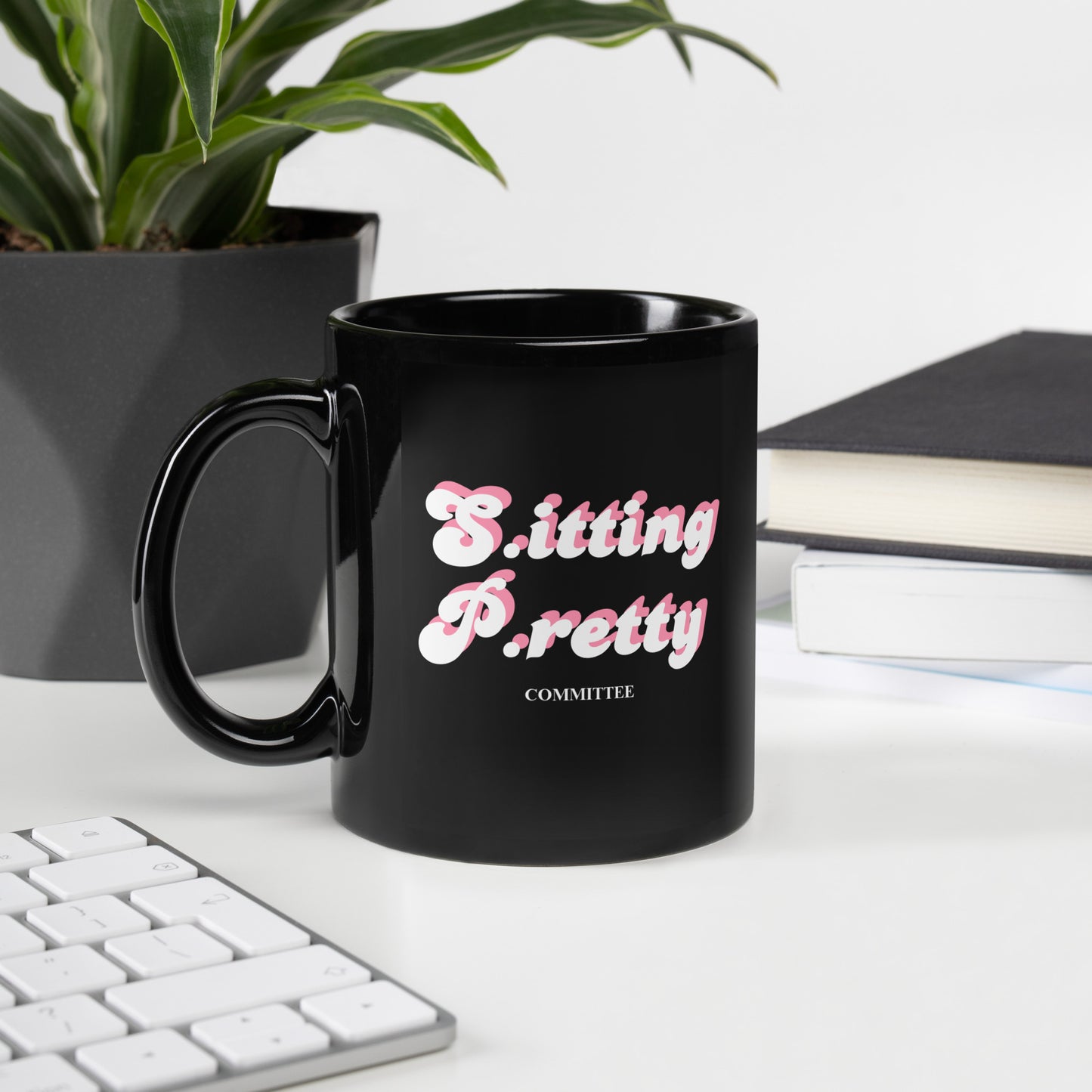 Black ceramic mug with “Sitting Pretty” bold text design, perfect for stylish and confident sips