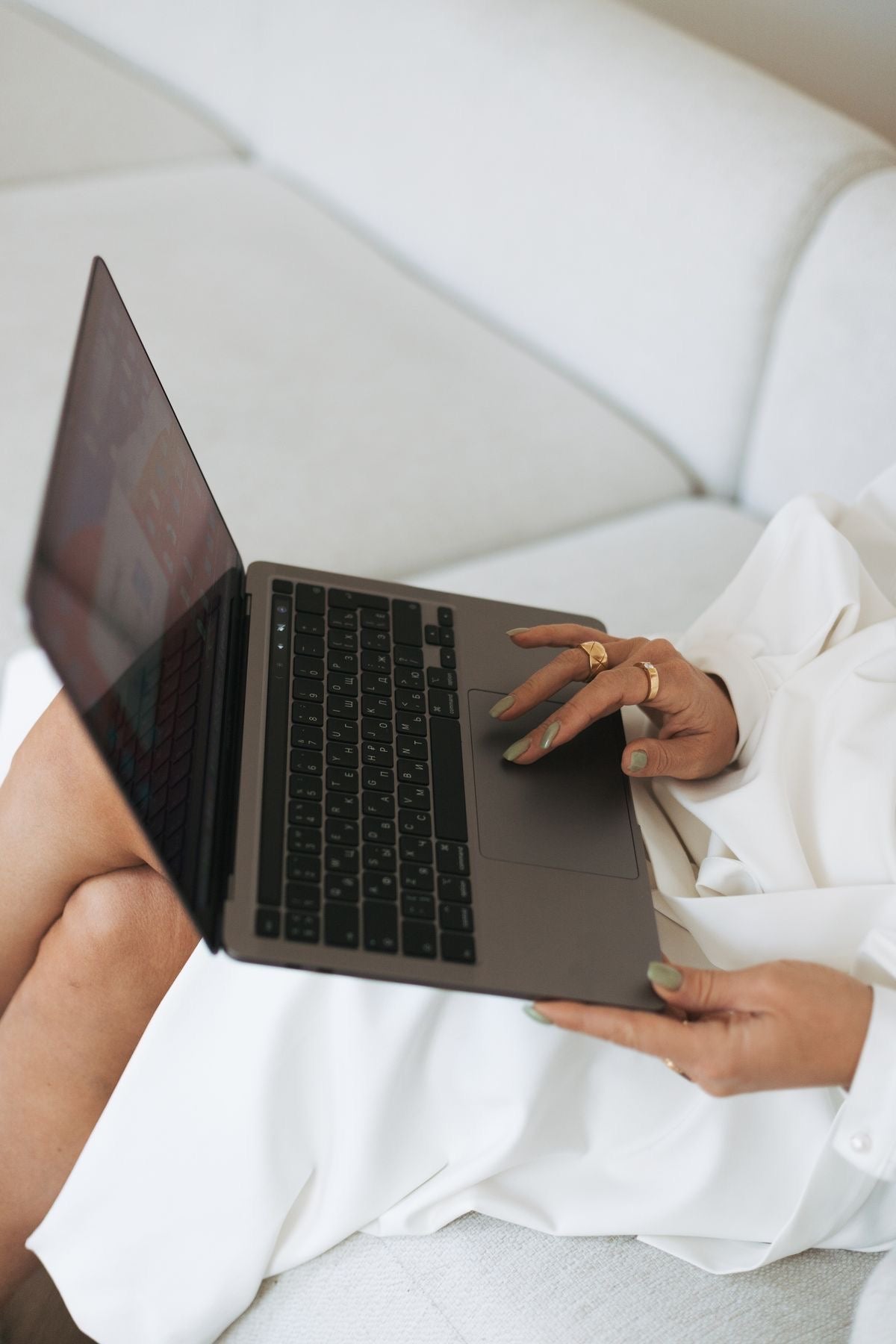 Woman typing on a MacBook, symbolizing focus and burnout recovery during work and healing process.